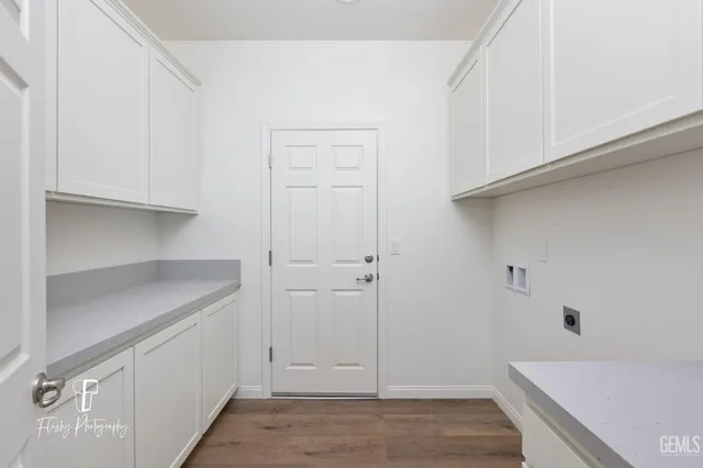a view of a kitchen with white cabinets