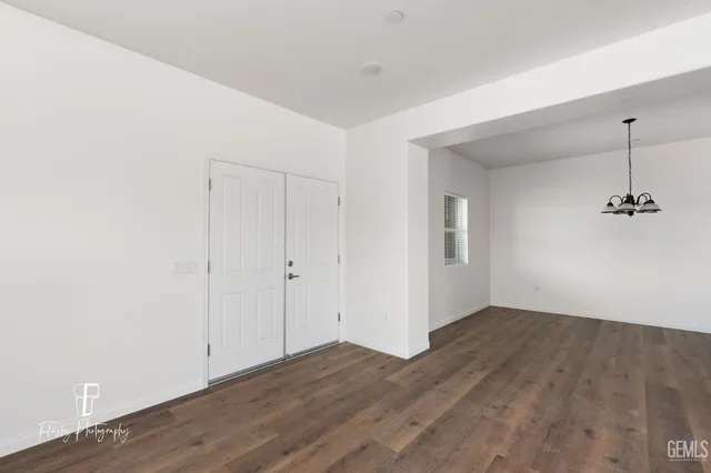 a view of a room with wooden floor