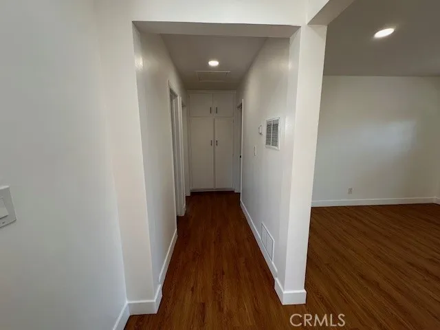 14621 Clark Street Baldwin Park, CA 91706 - Photo 11 of 28 a view of a hallway with wooden floor and staircase