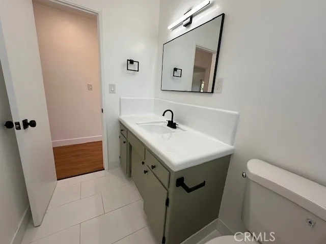 14621 Clark Street Baldwin Park, CA 91706 - Photo 13 of 28 a bathroom with a sink a toilet and vanity
