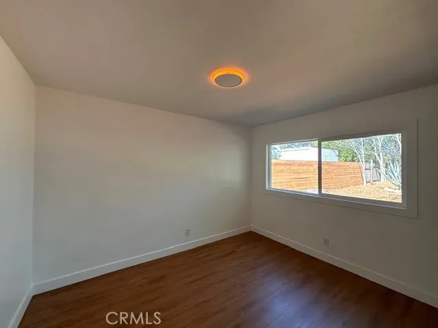 14621 Clark Street Baldwin Park, CA 91706 - Photo 16 of 28 an empty room with wooden floor and windows