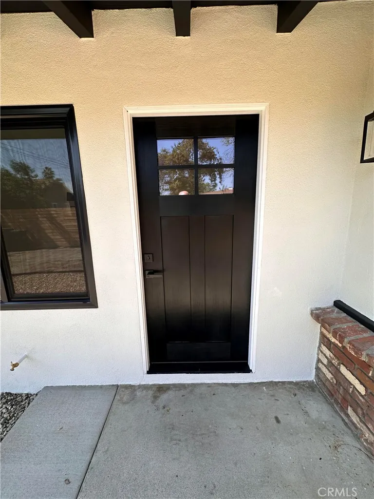 14621 Clark Street Baldwin Park, CA 91706 - Photo 3 of 28 a view of a hallway with wooden floor and cabinet