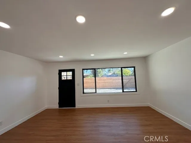 14621 Clark Street Baldwin Park, CA 91706 - Photo 5 of 28 a view of an empty room with wooden floor and a window