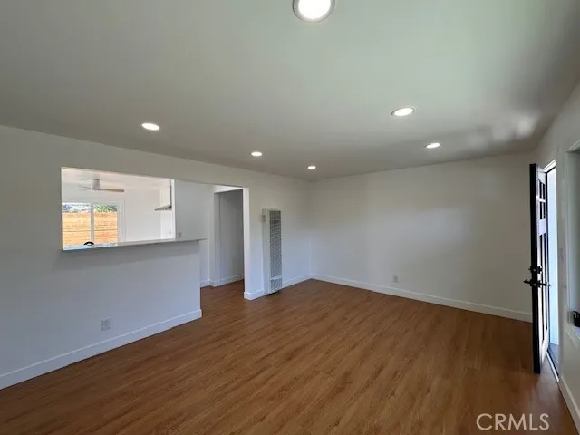 14621 Clark Street Baldwin Park, CA 91706 - Photo 7 of 28 an empty room with wooden floor and windows