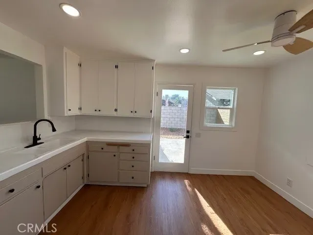 a view of a kitchen with sink and cabinets