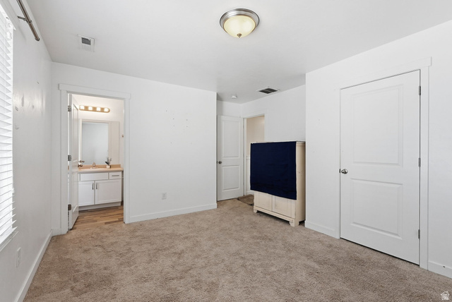 14764 Rising Star Way Riverton, UT 84065 - Photo 23 of 42 Carpeted flooring with white trim, a bathroom with wood-finish flooring, a single vanity with a light fixture, and a window with blinds