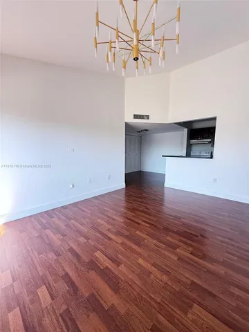 a view of a kitchen with a dishwasher and wooden floor