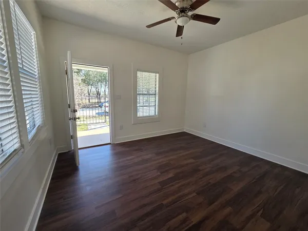 wooden floor in an empty room with a window