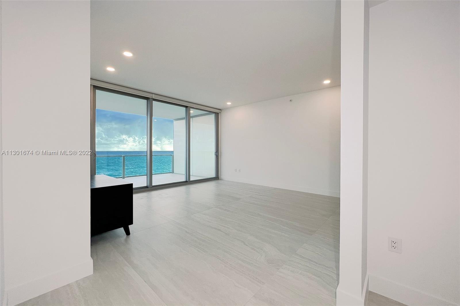 North Beach Miami Beach, FL 33141 - Photo 13 of 23 an empty room with wooden floor and windows