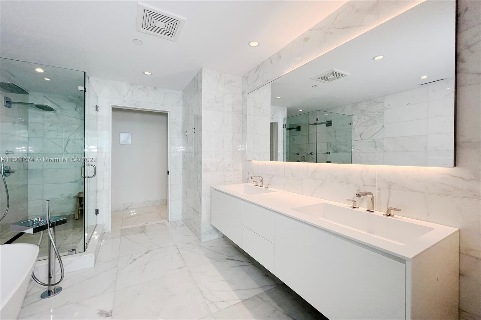 North Beach Miami Beach, FL 33141 - Photo 15 of 23 a large bathroom with a double vanity sink mirror and shower