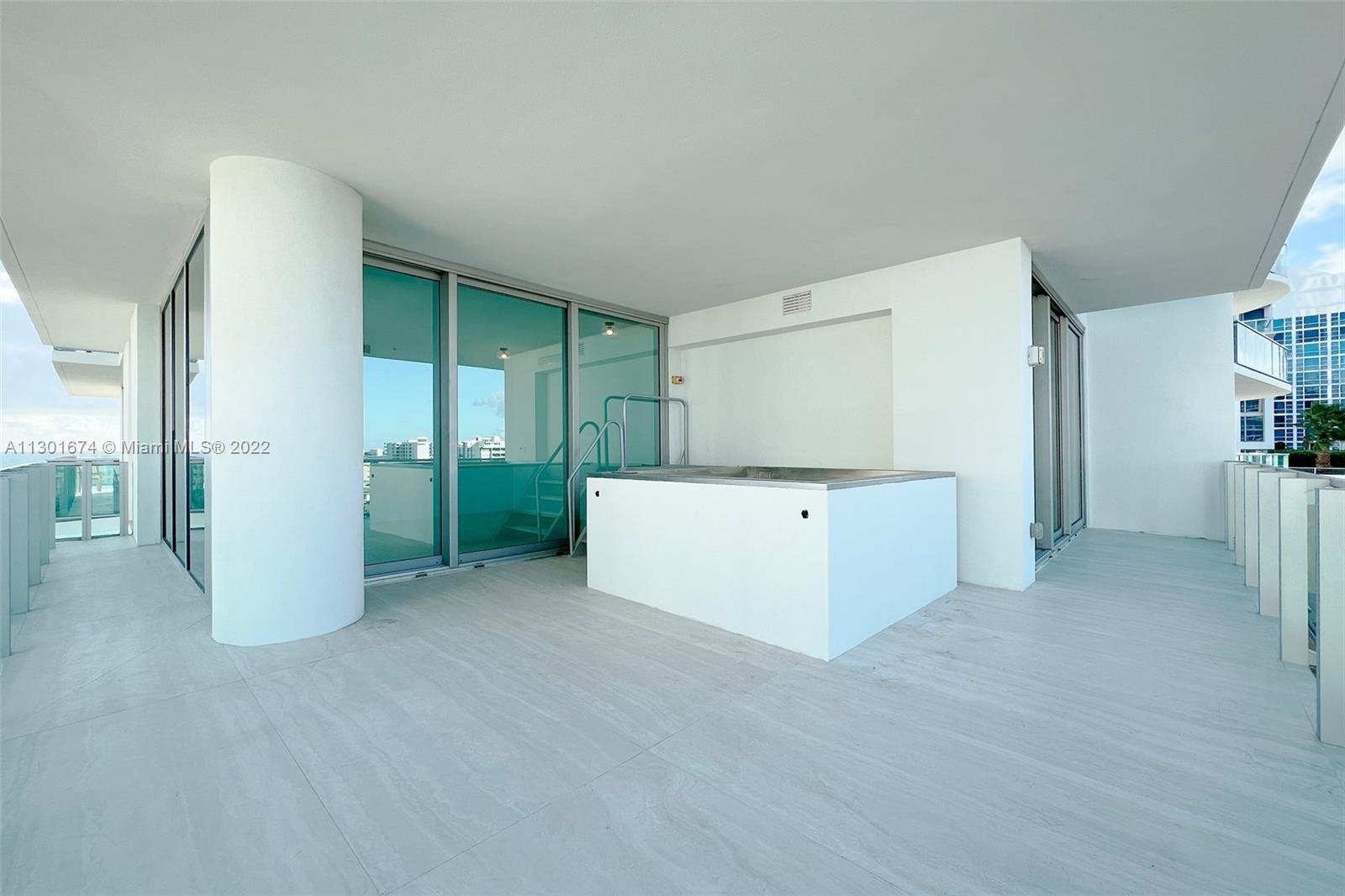 North Beach Miami Beach, FL 33141 - Photo 22 of 23 a view of a kitchen with furniture and an empty room