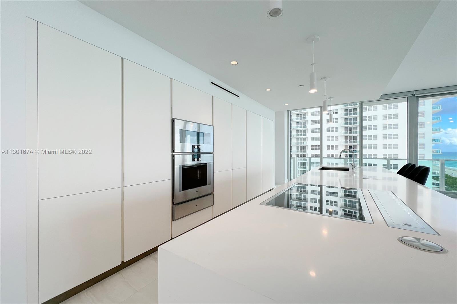 North Beach Miami Beach, FL 33141 - Photo 23 of 23 a large white bedroom with a large bed and a large window