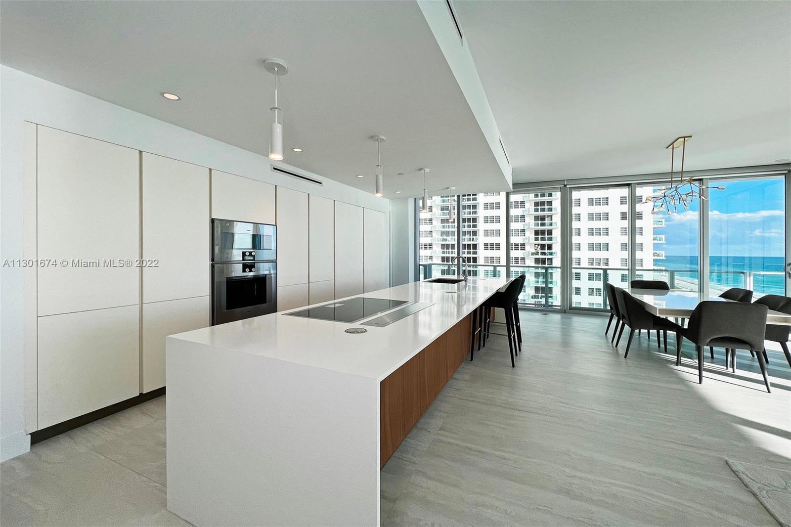 North Beach Miami Beach, FL 33141 - Photo 4 of 23 a dining hall with stainless steel appliances granite countertop furniture a large window and a kitchen view