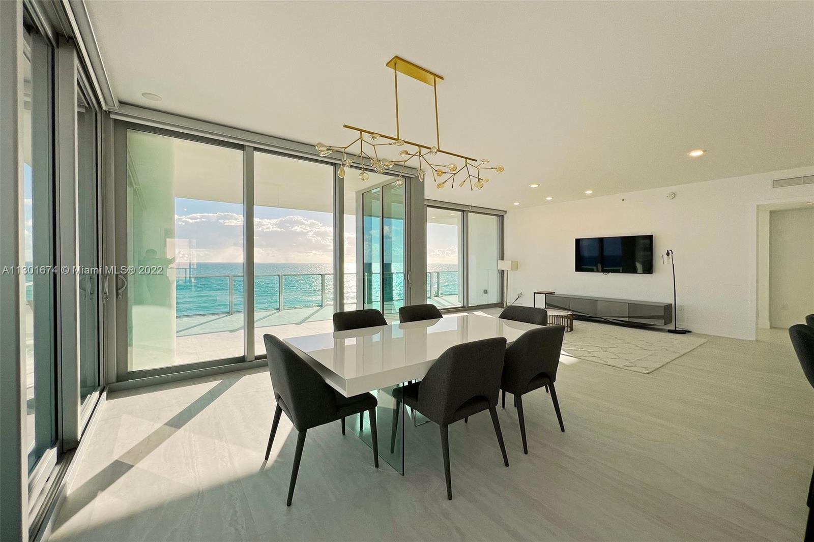 North Beach Miami Beach, FL 33141 - Photo 9 of 23 a view of a dining room with furniture window and wooden floor