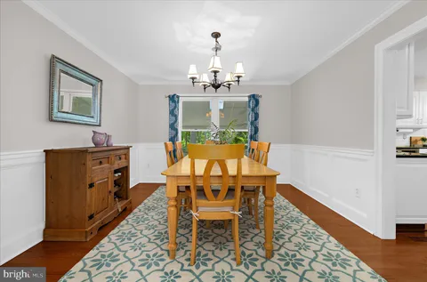 a kitchen with stainless steel appliances granite countertop a sink a stove a microwave and wooden cabinets