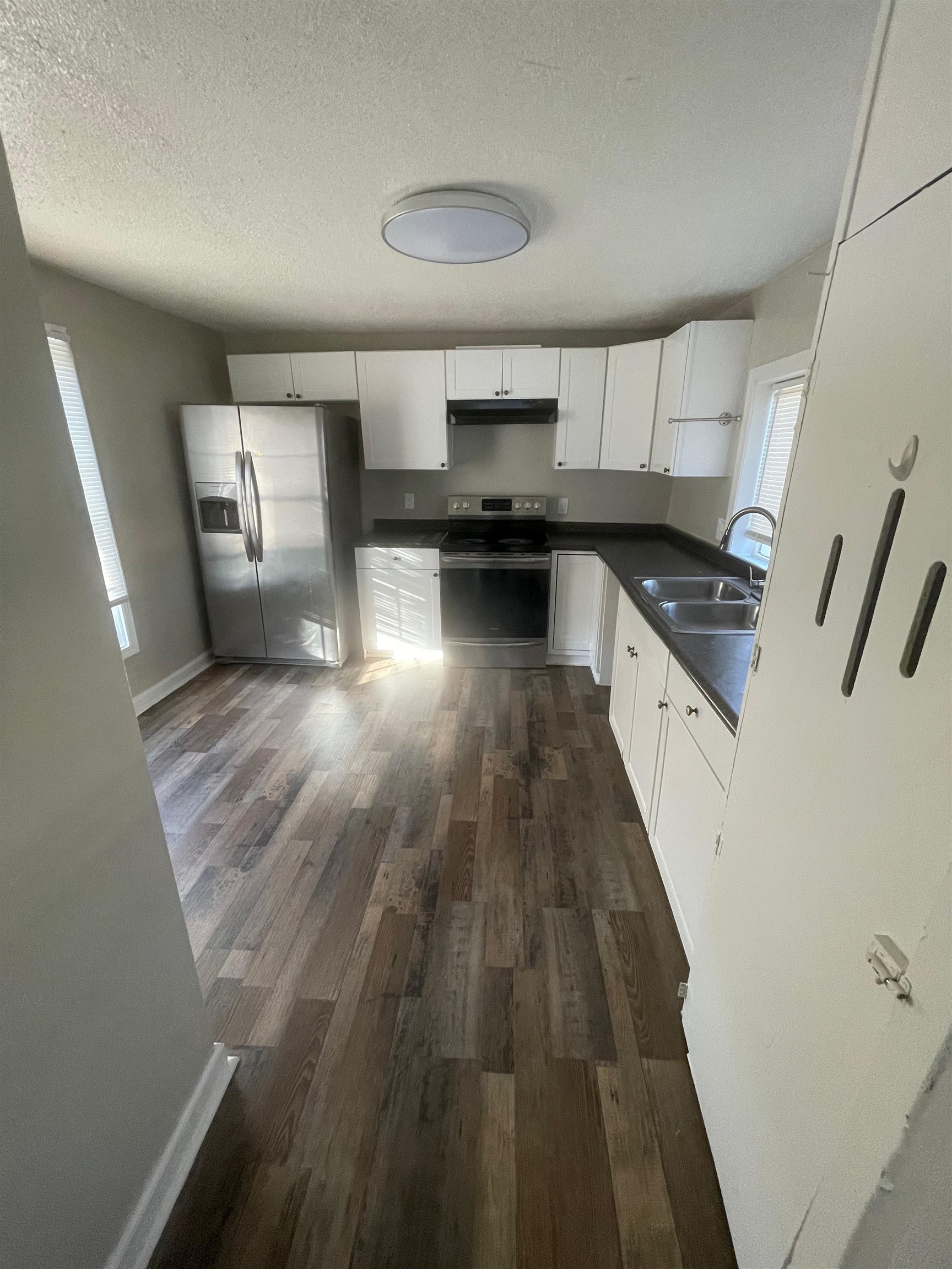 3466 Carrington Road Memphis, TN 38111 - Photo 12 of 14 a kitchen with granite countertop a refrigerator a sink dishwasher and a stove