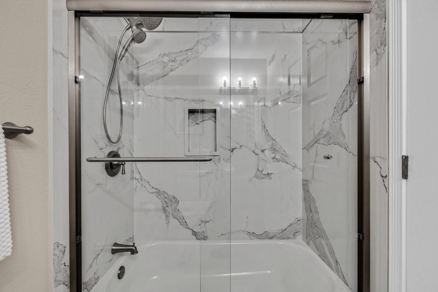 463 Becado Place Fremont, CA 94539 - Photo 22 of 74 a bathroom with a glass shower door