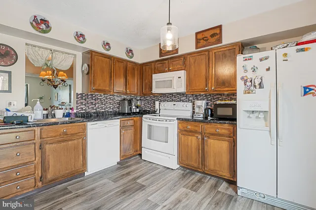 a view of a workspace with furniture and wooden floor