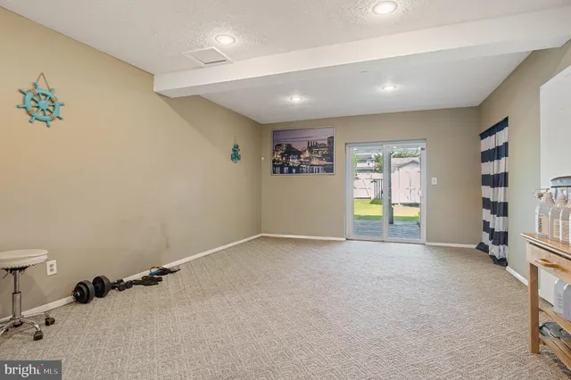 a view of an empty room with window and workspace