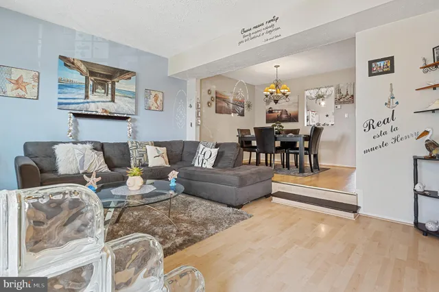 a living room with furniture and a chandelier