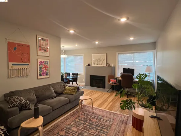 a living room with furniture a fireplace and a table