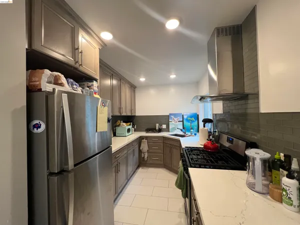 a kitchen with refrigerator and cabinets