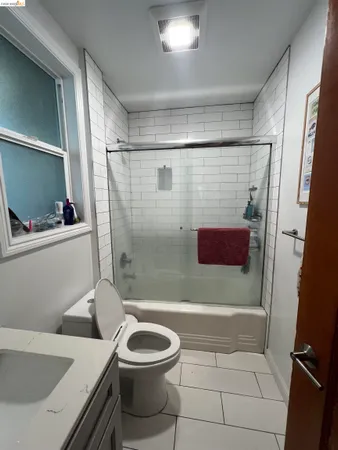 a bathroom with a toilet a sink and shower