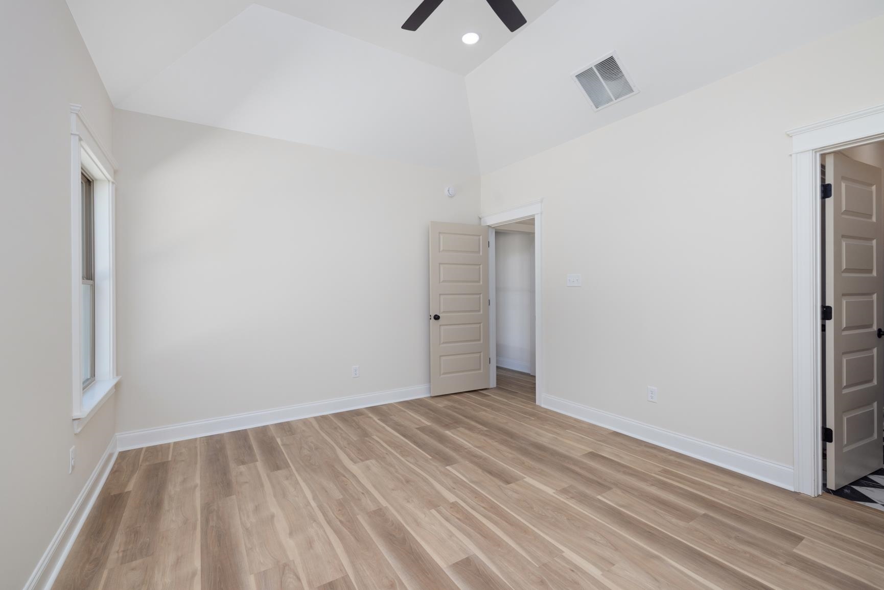 319 North Maple Street Covington, TN 38019 - Photo 19 of 32 a view of an empty room with wooden floor and a window