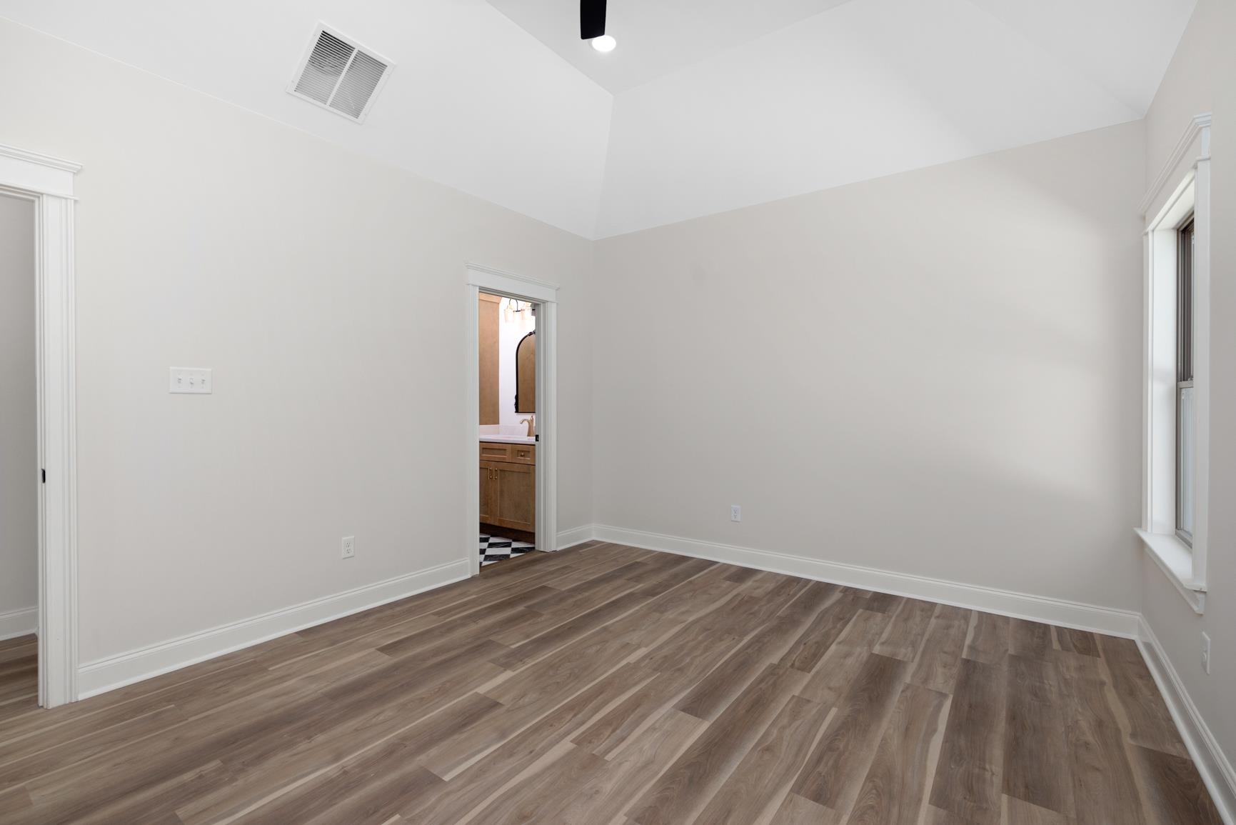 319 North Maple Street Covington, TN 38019 - Photo 20 of 32 a view of room with window and hardwood floor