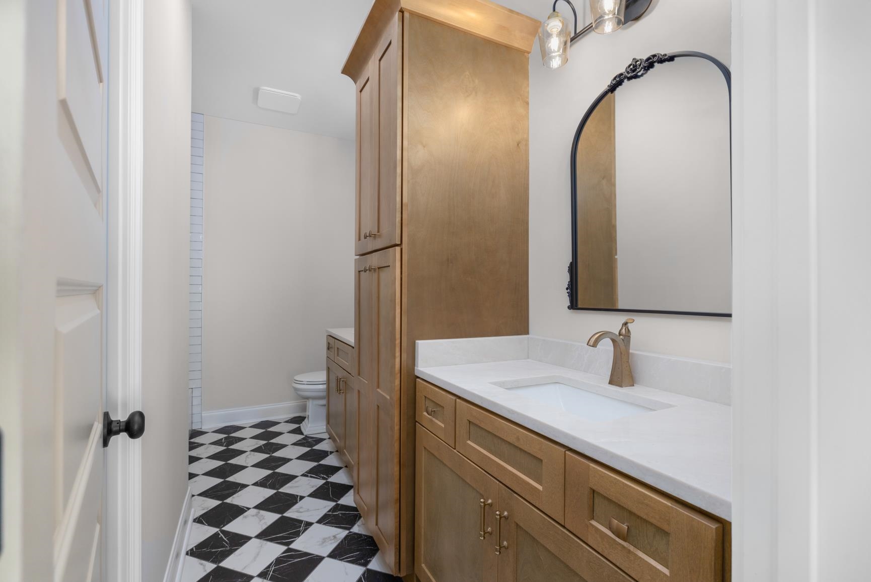 319 North Maple Street Covington, TN 38019 - Photo 21 of 32 a bathroom with a sink and a mirror