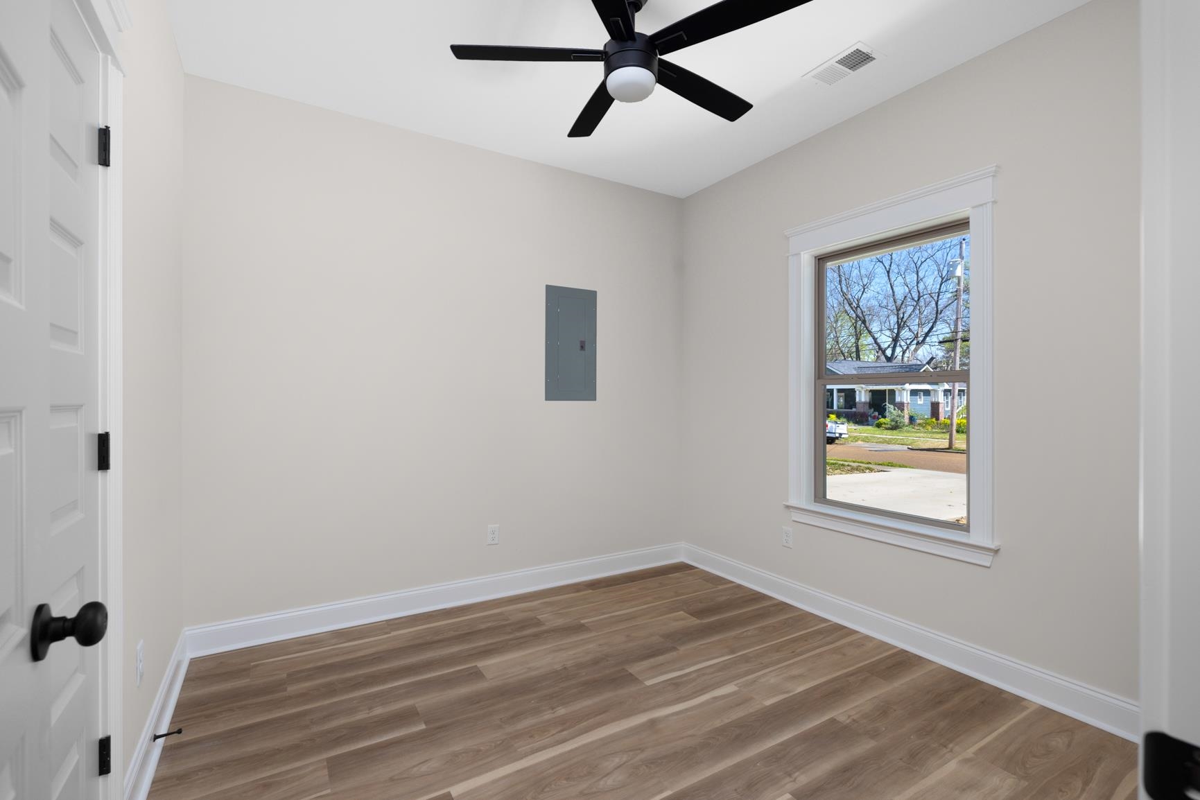 319 North Maple Street Covington, TN 38019 - Photo 24 of 32 a view of an empty room with wooden floor and a window