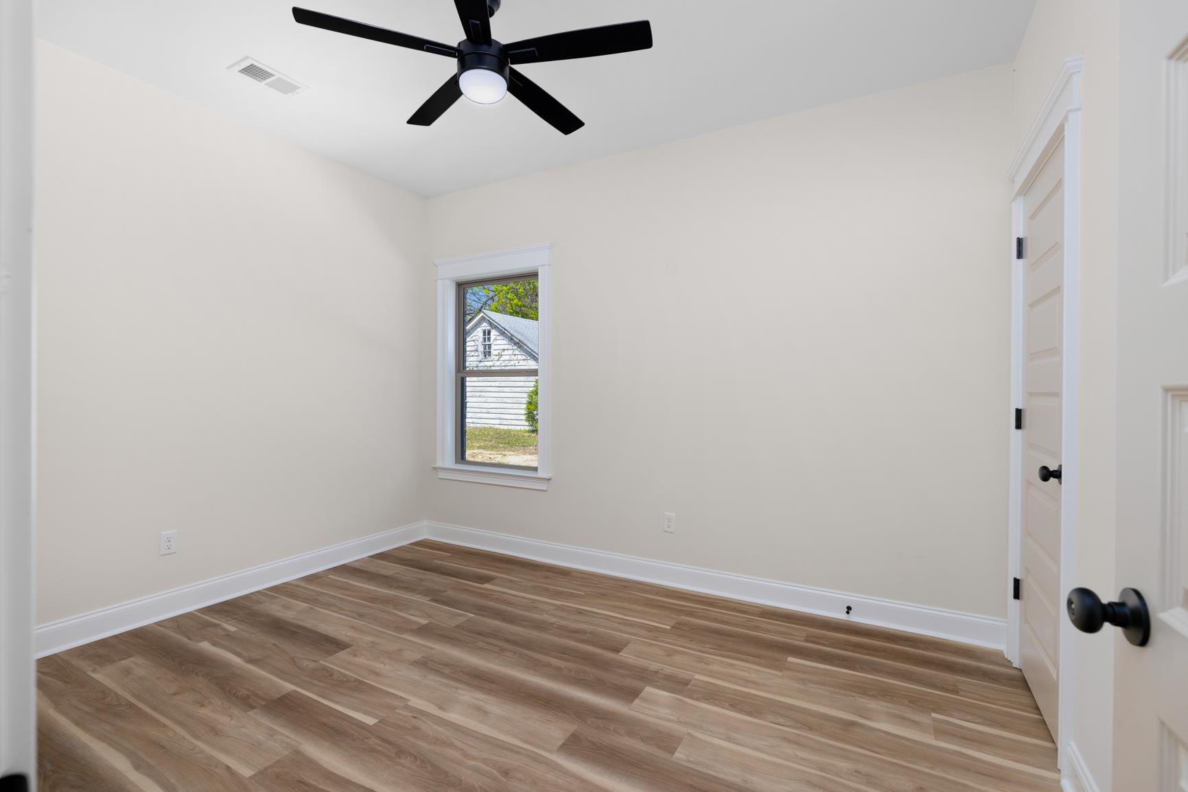 319 North Maple Street Covington, TN 38019 - Photo 26 of 32 a view of a room with window and hardwood floor