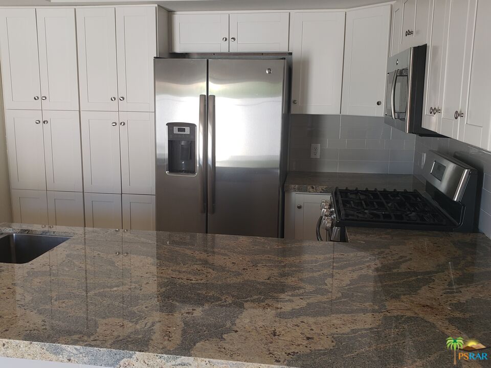 35989 Alameda Court Rancho Mirage, CA 92270 - Photo 2 of 4 a kitchen with stainless steel appliances a refrigerator and a stove