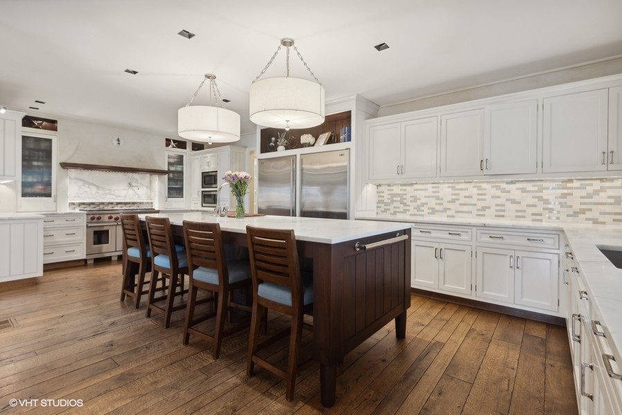 710 South County Line Road Hinsdale, IL 60521 - Photo 13 of 63 a kitchen with stainless steel appliances a table chairs and a refrigerator