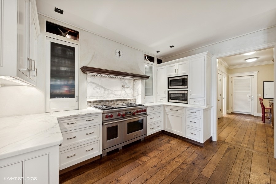 710 South County Line Road Hinsdale, IL 60521 - Photo 15 of 63 a kitchen with stainless steel appliances a stove top oven and wooden floor