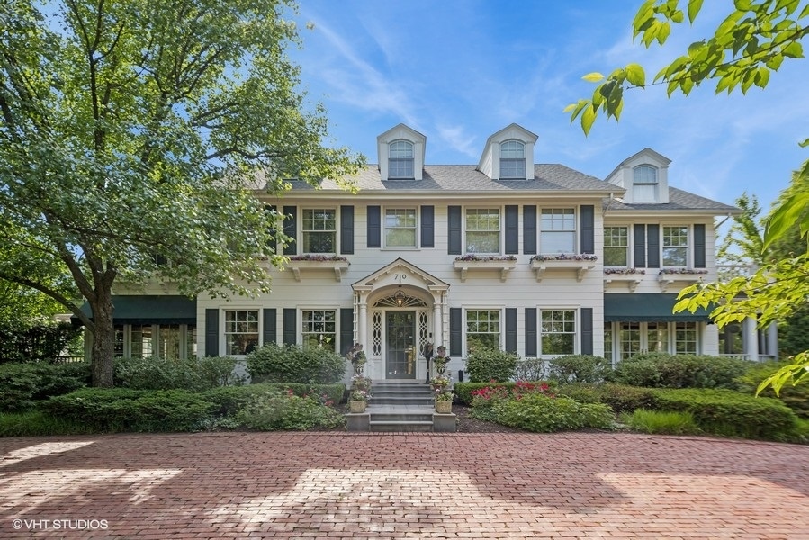 710 South County Line Road Hinsdale, IL 60521 - Photo 2 of 63 a front view of a house with a garden