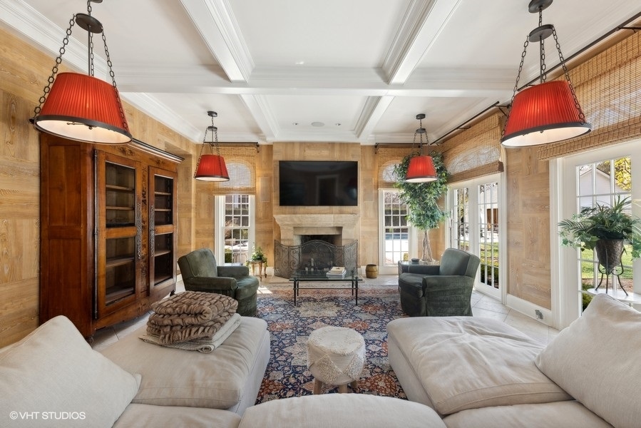 710 South County Line Road Hinsdale, IL 60521 - Photo 23 of 63 a living room with furniture a fireplace and a flat screen tv