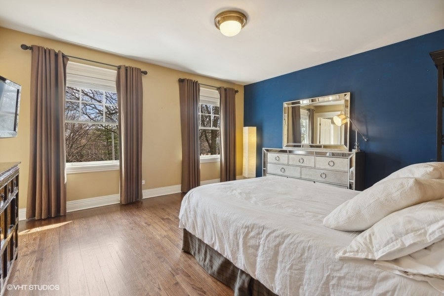 710 South County Line Road Hinsdale, IL 60521 - Photo 38 of 63 a bedroom with a bed and a dresser next to a window