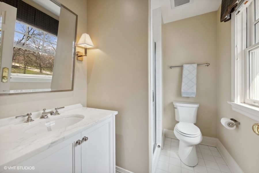 710 South County Line Road Hinsdale, IL 60521 - Photo 39 of 63 a bathroom with a toilet sink and mirror