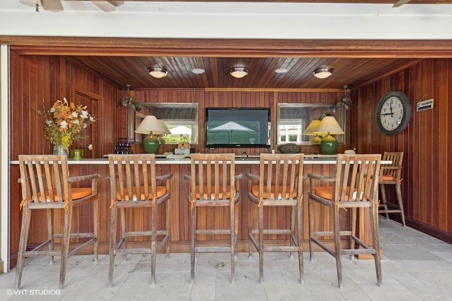 710 South County Line Road Hinsdale, IL 60521 - Photo 52 of 63 a kitchen with a dining table and chairs