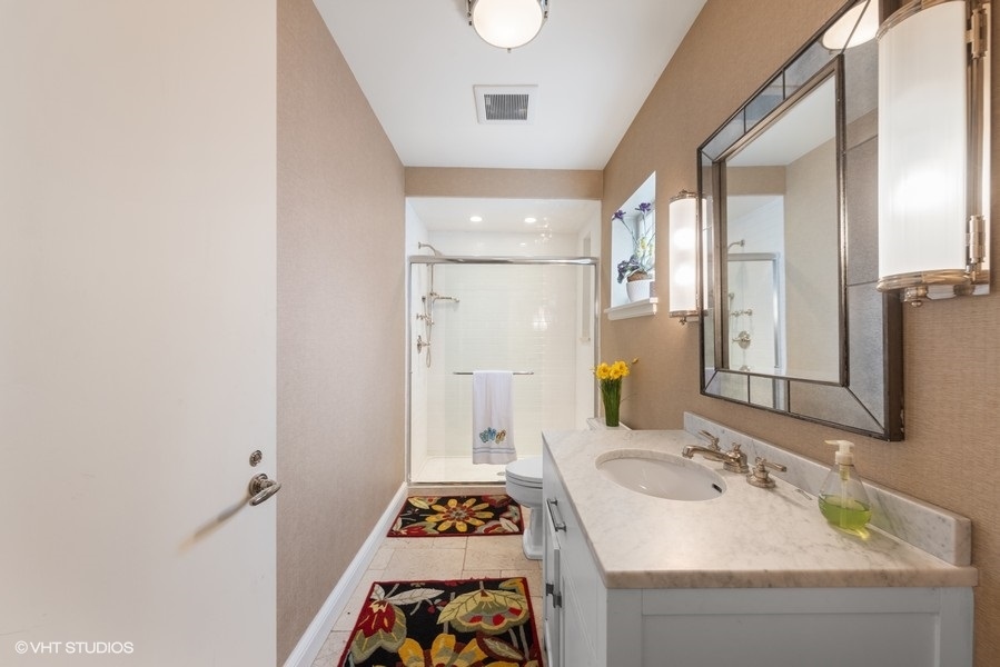 710 South County Line Road Hinsdale, IL 60521 - Photo 54 of 63 a bathroom with a sink a mirror and a shower