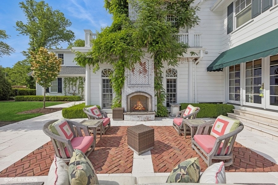 710 South County Line Road Hinsdale, IL 60521 - Photo 56 of 63 a view of a patio with couches chairs and a fire pit