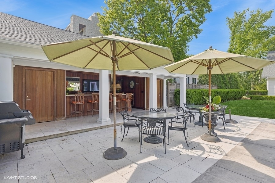 710 South County Line Road Hinsdale, IL 60521 - Photo 7 of 63 a view of a patio with a table and chairs under an umbrella