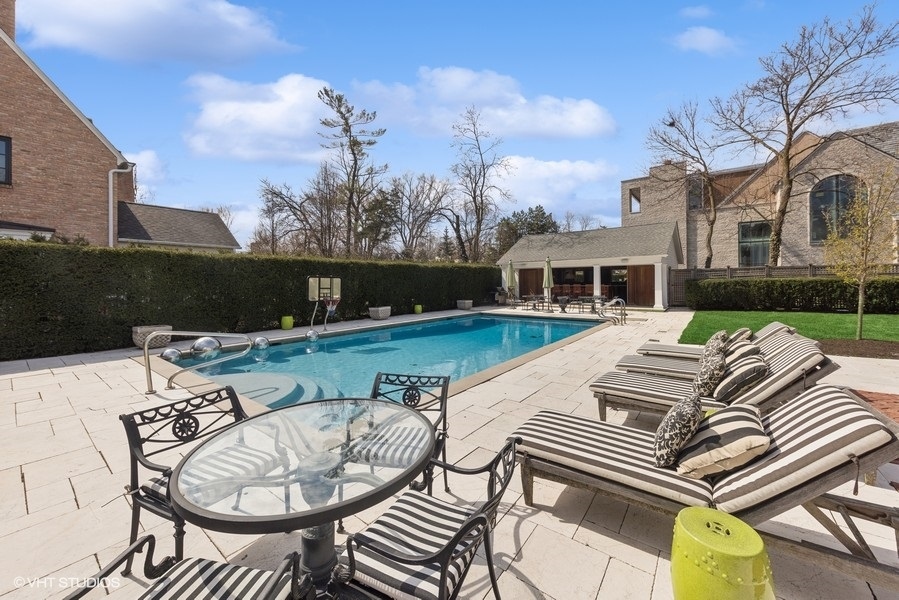 710 South County Line Road Hinsdale, IL 60521 - Photo 8 of 63 a view of a patio with table and chairs with wooden floor and fence
