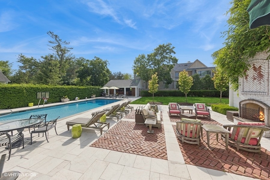 710 South County Line Road Hinsdale, IL 60521 - Photo 9 of 63 a view of a swimming pool with lounge chairs in patio