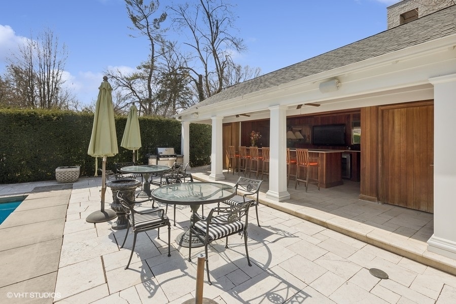 710 South County Line Road Hinsdale, IL 60521 - Photo 10 of 63 a view of a patio with table and chairs and potted plants