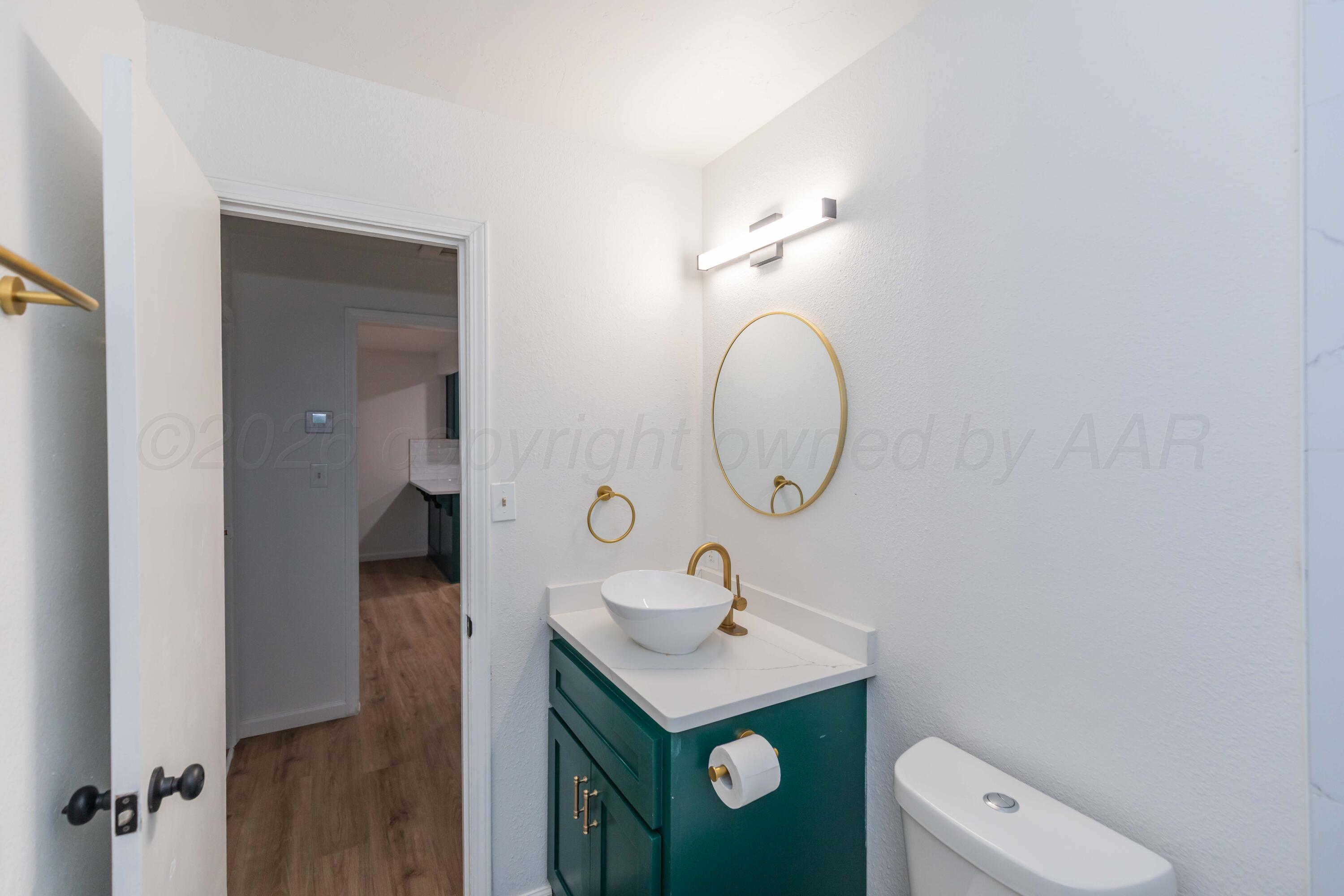 205 South Forest Street Amarillo, TX 79106 - Photo 15 of 29 a bathroom with a toilet sink and mirror