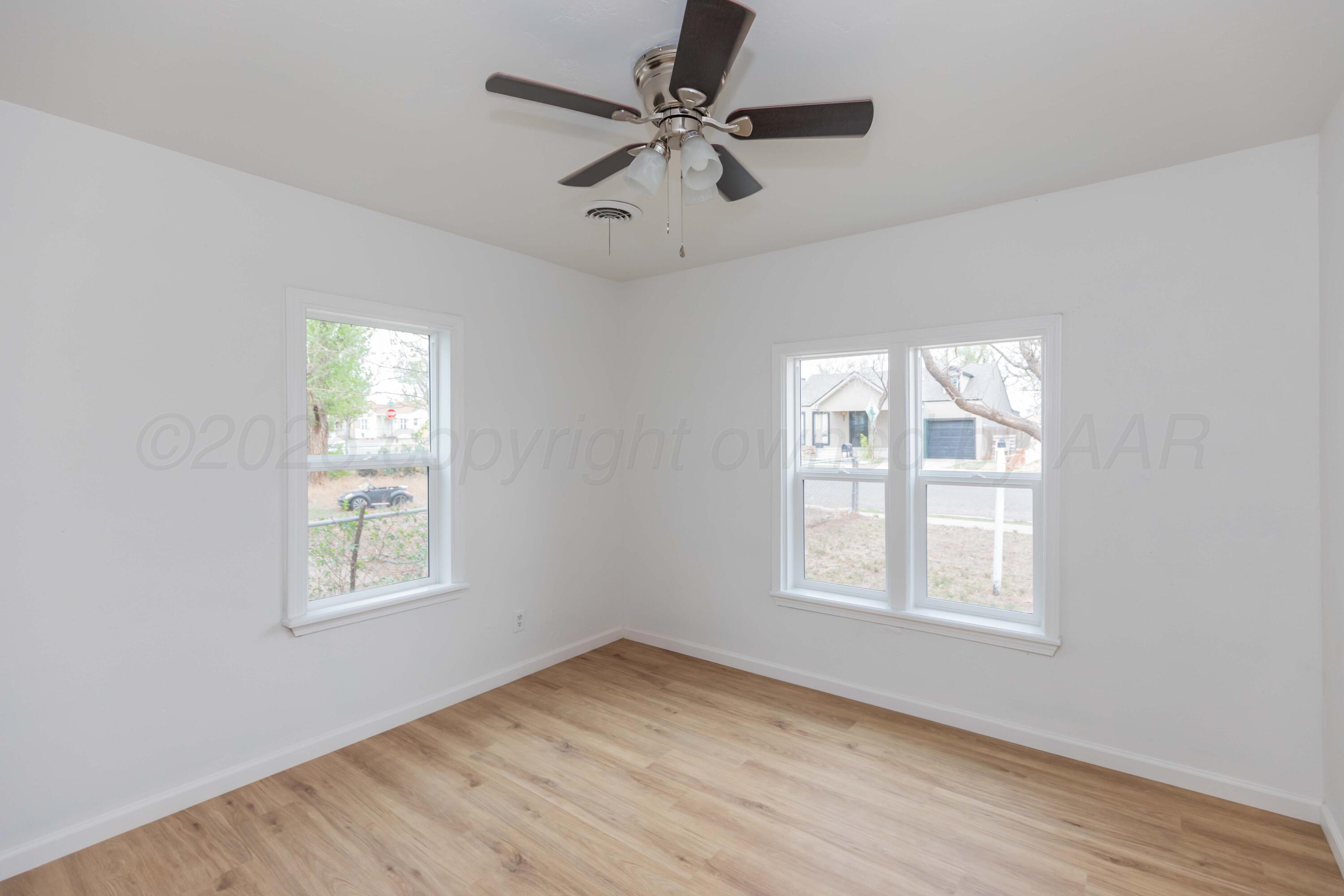 205 South Forest Street Amarillo, TX 79106 - Photo 24 of 29 a view of an empty room with a window and wooden floor