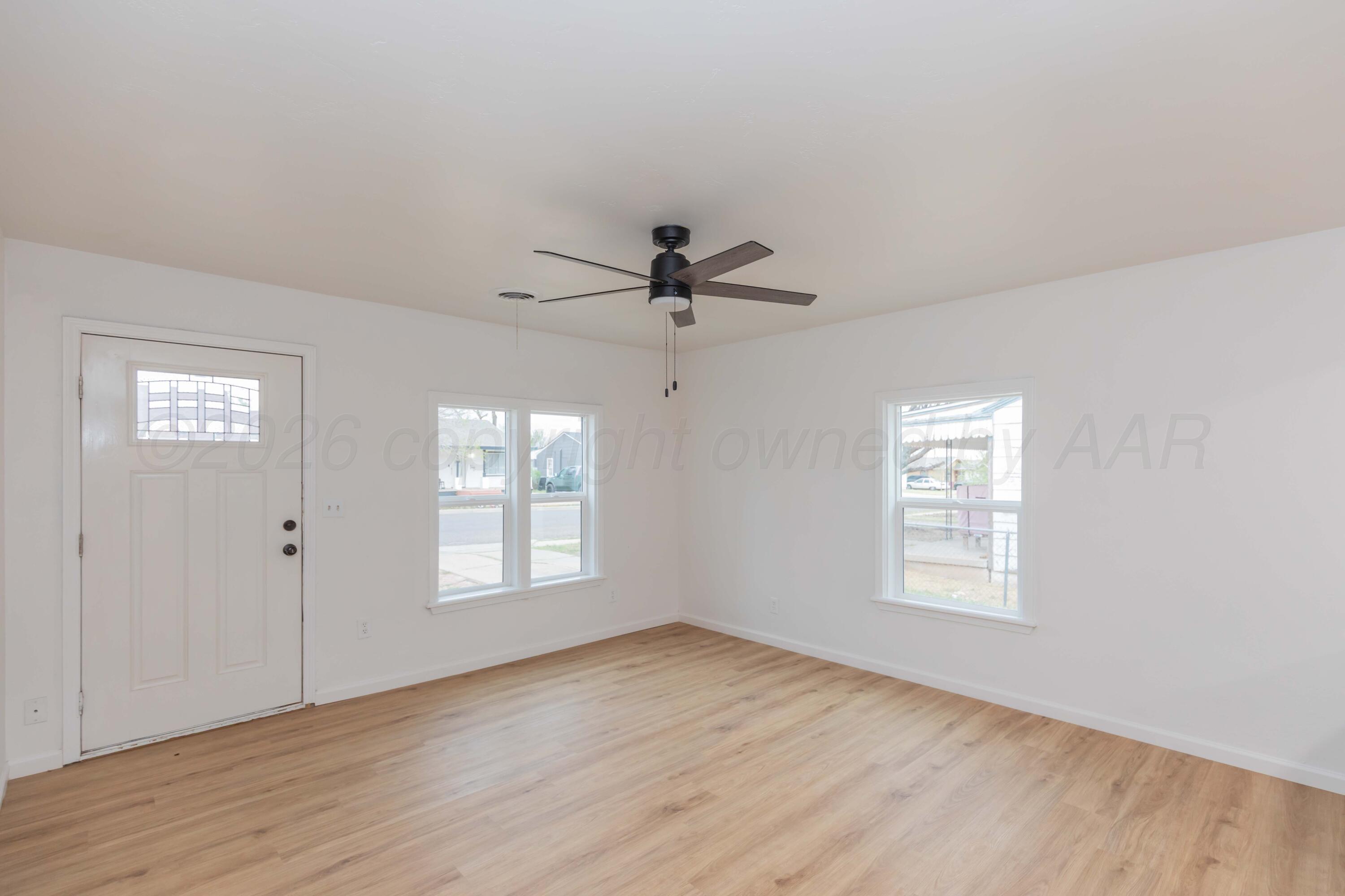 205 South Forest Street Amarillo, TX 79106 - Photo 4 of 29 a view of empty room with wooden floor and fan