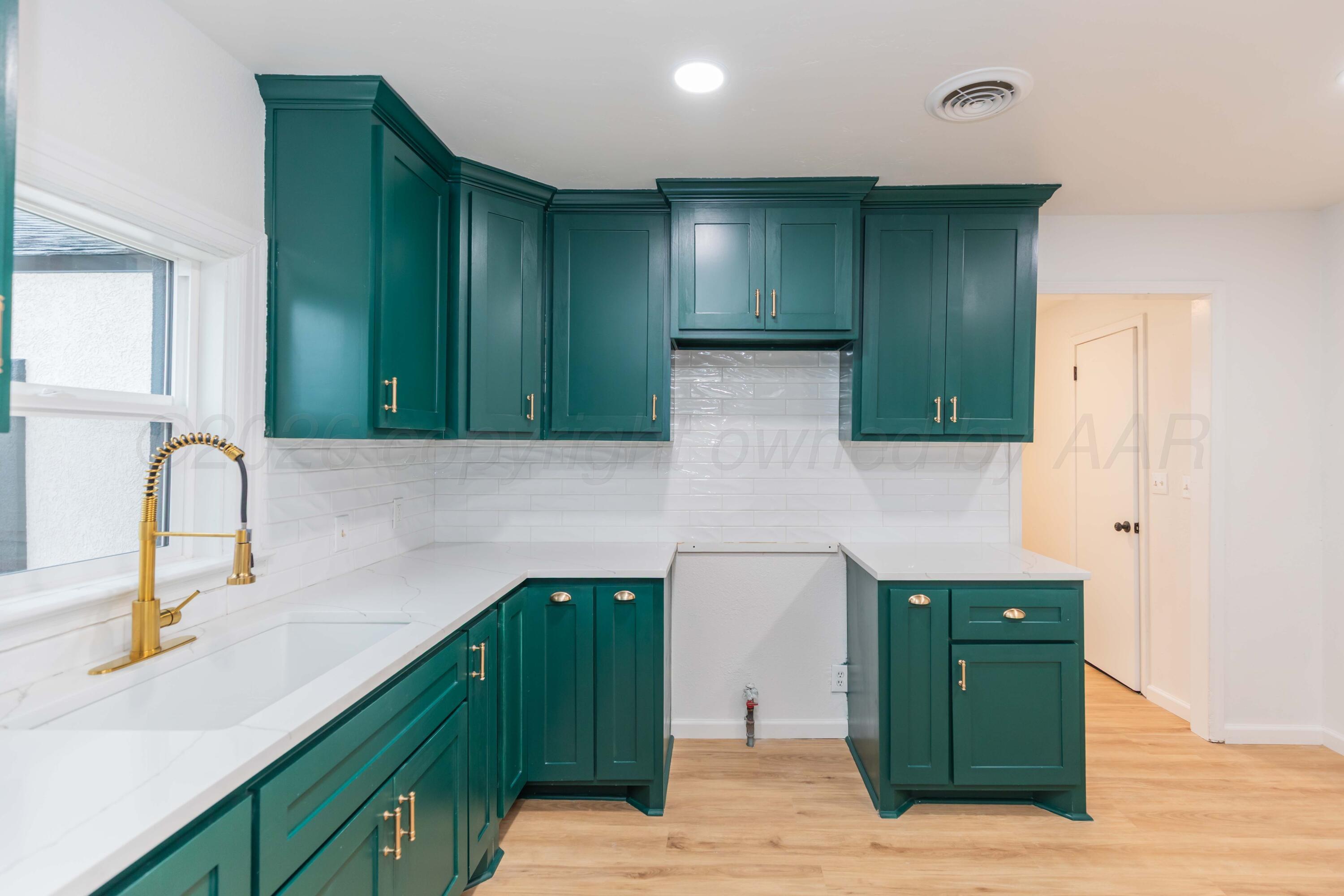 205 South Forest Street Amarillo, TX 79106 - Photo 7 of 29 a kitchen with a sink and a refrigerator